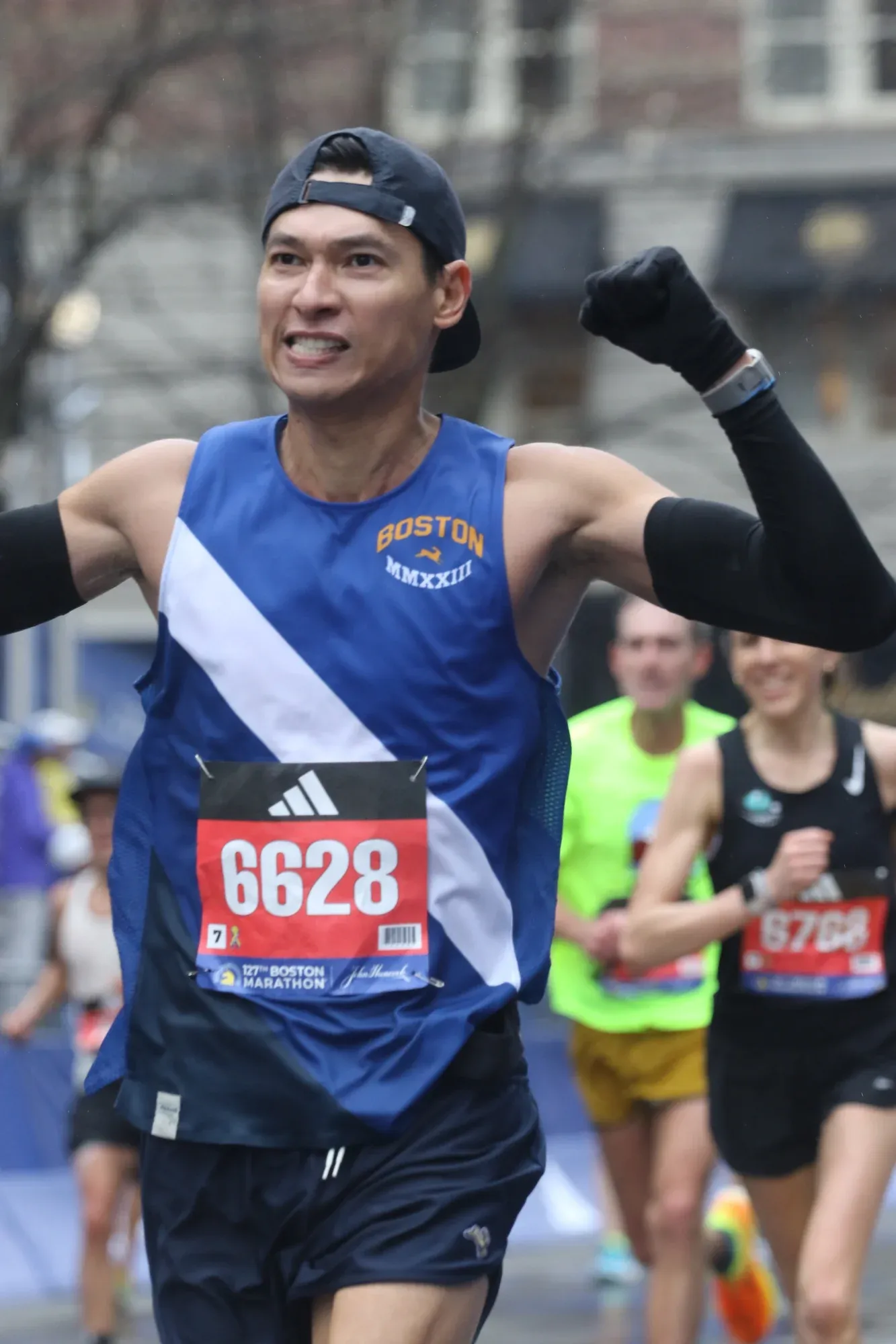 Sardar Azimov celebrating at the Boston Marathon finish 2023